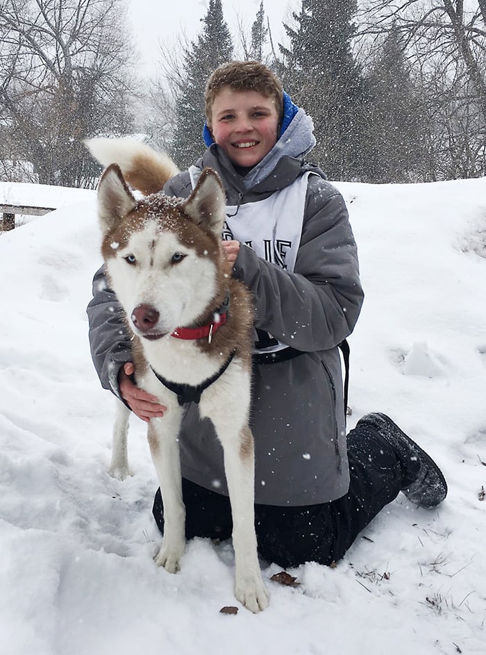 Kid and Siberian Husky Outside in the Snow | Diamond Pet Foods
